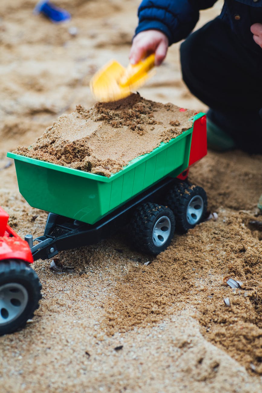 child's dump truck filled with sand