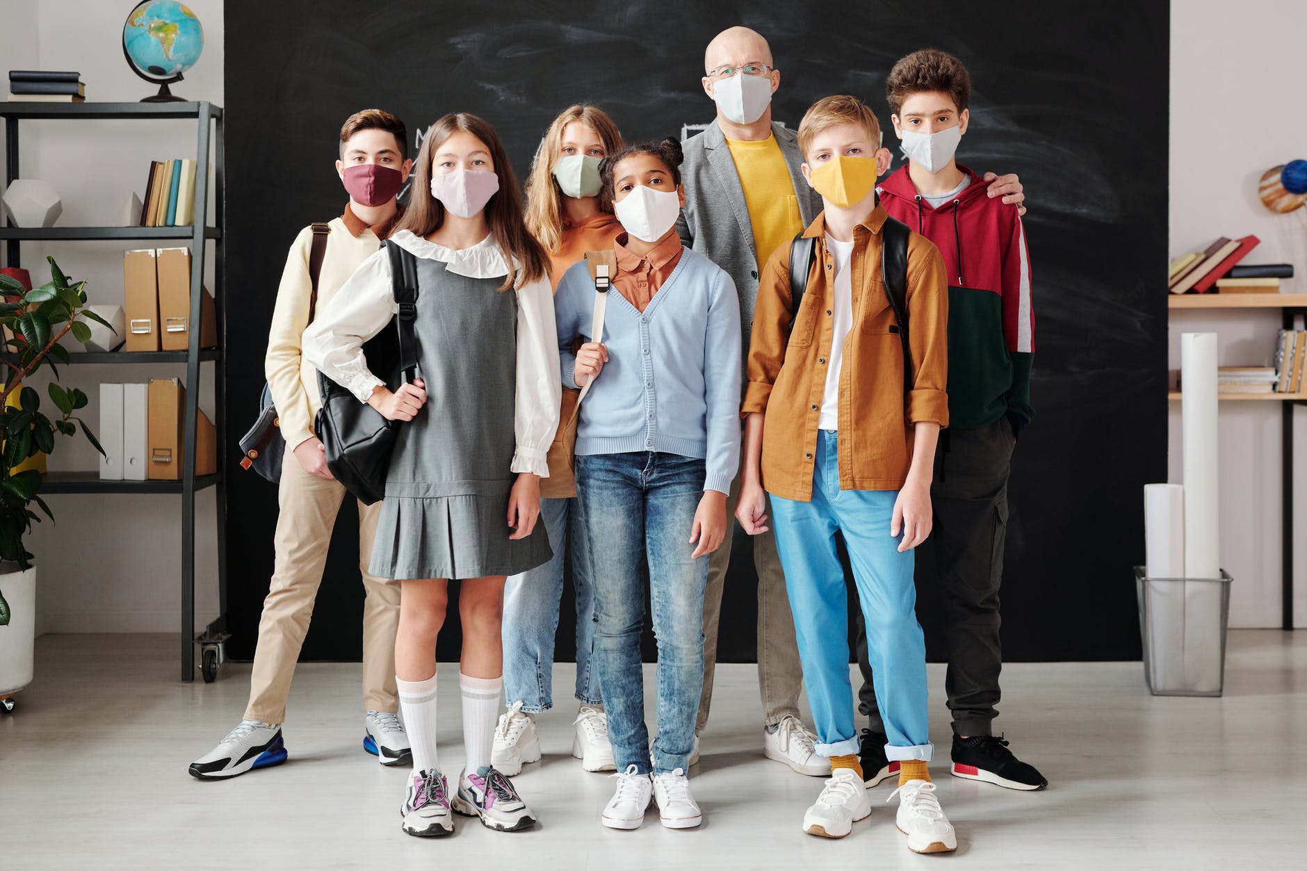 group of students with a teacher standing together with masks on.